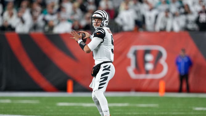Joe Burrow of the Cincinnati Bengals throws a pass against the Miami Dolphins at Paycor Stadium on September 29, 2022 in Cincinnati, Ohio. That was the only game in 2022 that the team wore its black-and-white alternate uniforms and white helmet and Kay Adams says they'll wear them again in Week 3 against the Los Angeles Rams.