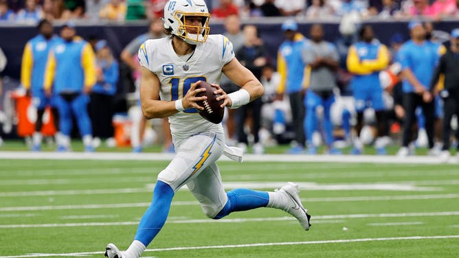 Los Angeles Chargers QB Justin Herbert rolls out to pass in the 2nd quarter against the Houston Texans at NRG Stadium in Houston.
