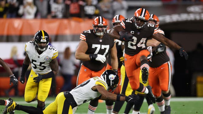 Cleveland Browns RB Nick Chubb jumps over Pittsburgh Steelers S Minkah Fitzpatrick at FirstEnergy Stadium in Cleveland, Ohio.