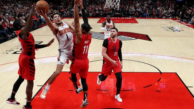 Phoenix Suns Devin Booker attacks the rim against the Portland Trail Blazers during the 3rd quarter at Moda Center in Portland, Oregon.