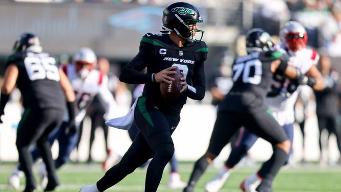 New York Jets QB Zach Wilson rolling out to pass against the New England Patriots at MetLife Stadium in East Rutherford, New Jersey.