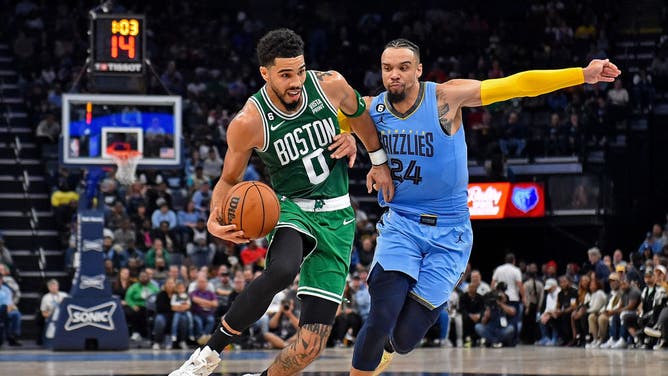 Celtics' Jayson Tatum goes to the basket against Grizzlies wing Dillon Brooks at FedExForum in Memphis, Tennessee.