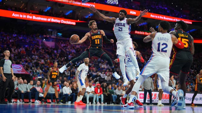 Atlanta Hawks PG Trae Young passes the ball against Philadelphia 76ers C Joel Embiid at the Wells Fargo Center in Philadelphia.