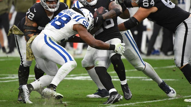 Las Vegas Raiders RB Josh Jacobs is getting tackled by Indianapolis Colts LB Bobby Okereke at Allegiant Stadium in Las Vegas.
