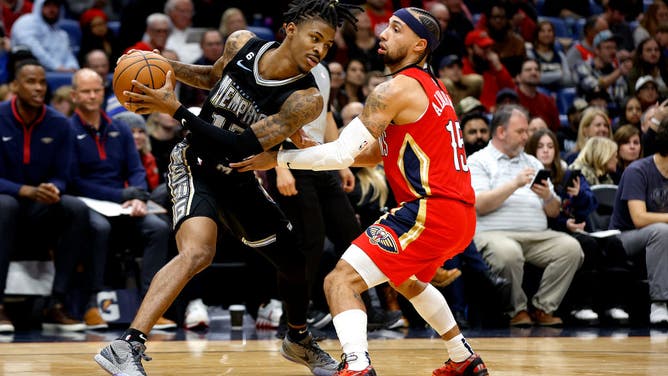Memphis Grizzlies PG Ja Morant is defended by New Orleans Pelicans PG Jose Alvarado during the fourth quarter of an NBA game at Smoothie King Center in New Orleans.