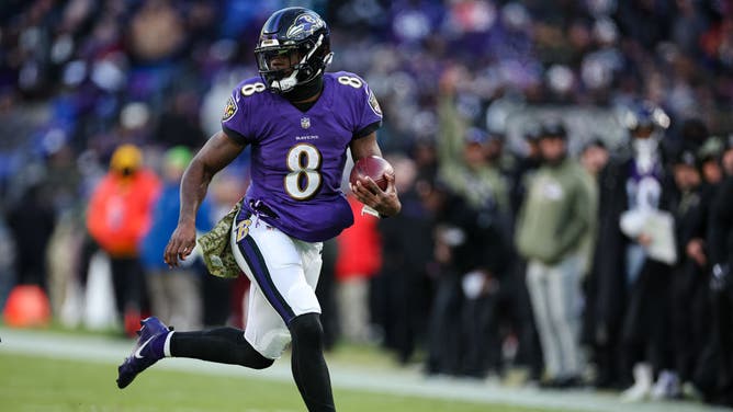 Baltimore Ravens QB Lamar Jackson carries the ball against the Carolina Panthers at M&T Bank Stadium in Baltimore, Maryland.