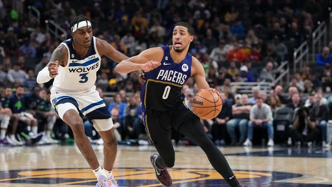 Indiana Pacers PG Tyrese Haliburton dribbles the ball while being guarded by Minnesota Timberwolves F Jaden McDaniels in the 1st quarter at Gainbridge Fieldhouse in Indianapolis.