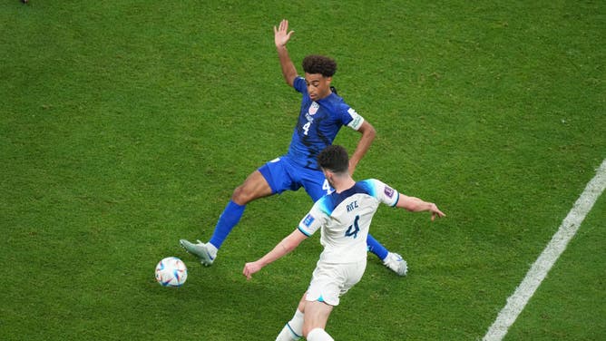 US Soccer captain Tyler Adams plays a ball against England at the World Cup. USA faces Iran on Tuesday.