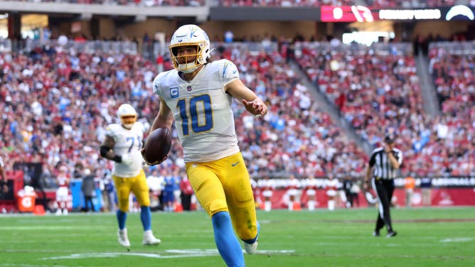 Los Angeles Chargers QB Justin Herbert scrambles for yardage against the Arizona Cardinals at State Farm Stadium in Glendale, Arizona.