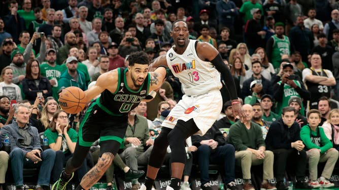 Tatum dribbles past Heat big Bam Adebayo at TD Garden in Boston.