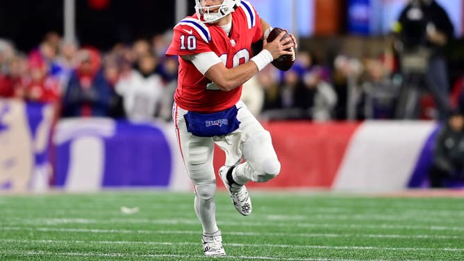 New England Patriots QB Mac Jones carries the ball during a game against the Buffalo Bills at Gillette Stadium in Foxborough, Massachusetts.