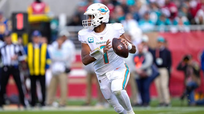 Miami Dolphins QB Tua Tagovailoa rolls out to throw a pass against the San Francisco 49ers at Levi's Stadium in Santa Clara, California.