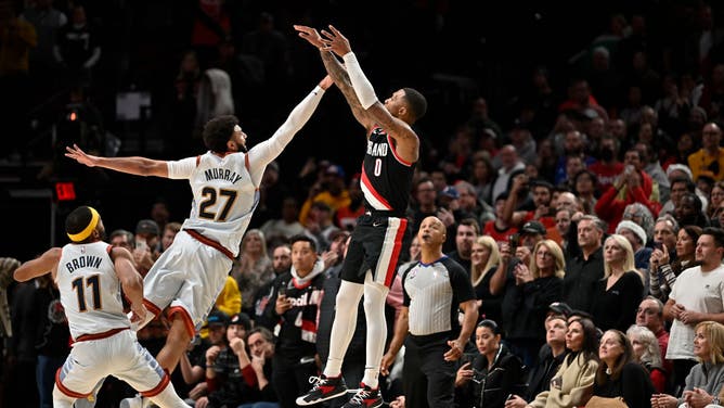 Portland Trail Blazers PG Damian Lillard shoots a 3-pointer over Denver Nuggets PG Jamal Murray at the Moda Center in Portland, Oregon.