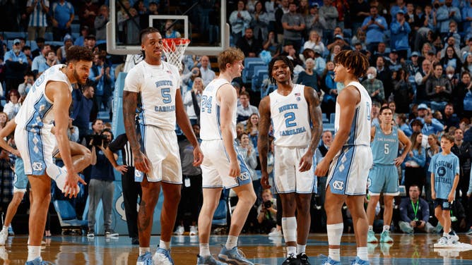 North Carolina Tar Heels players Pete Nance, Armando Bacot, Tyler Nickel, Caleb Love, and Seth Trimble huddle at the Dean Smith Center in Chapel Hill, North Carolina.