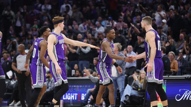 Sacramento Kings players Malik Monk, Kevin Huerter, De'Aaron Fox and Domantas Sabonis celebrate after a play against the Charlotte Hornets at Golden 1 Center in Sacramento, California.