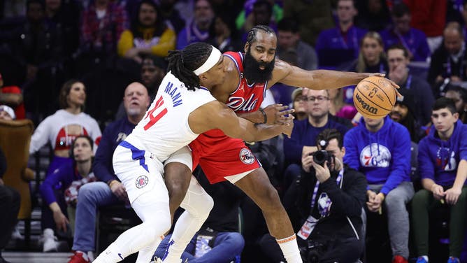 Los Angeles Clippers G/F Terance Mann defends Philadelphia 76ers' James Harden at Wells Fargo Center in Philadelphia.