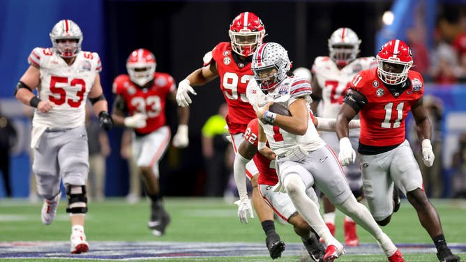 C.J. Stroud evades Georgia defenders in the Chick-fil-A Peach Bowl at Mercedes-Benz Stadium in Atlanta.