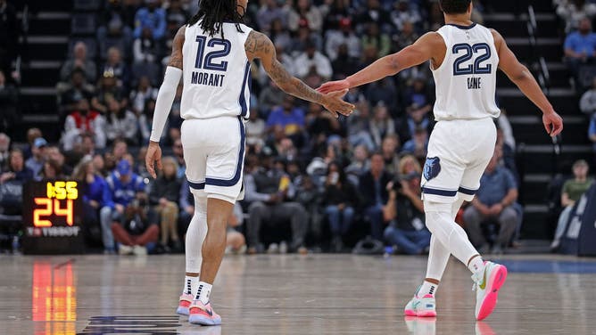 Grizzlies guards Ja Morant and Desmond Bane high-five at FedExForum in Memphis.