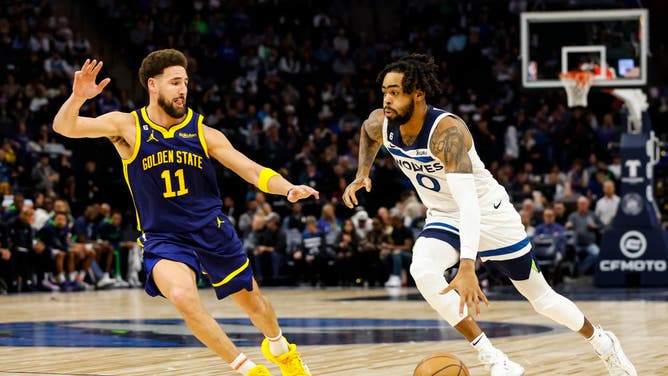 D'Angelo Russell while playing for the Timberwolves drives to the basket on Warriors' Klay Thompson at Target Center in Minneapolis, Minnesota.