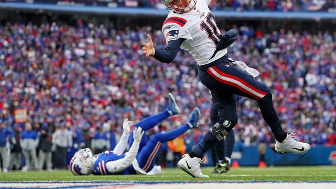 Patriots QB Mac Jones stumbles vs. the Buffalo Bills at Highmark Stadium.