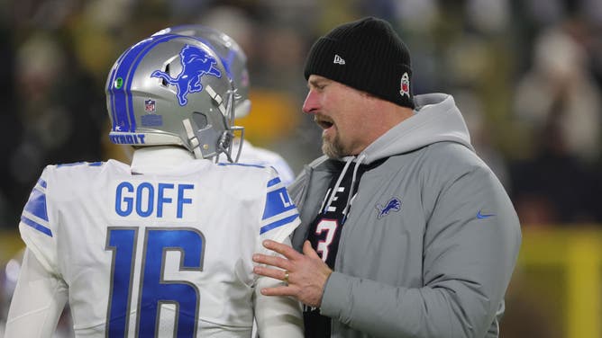Detroit Lions head coach Dan Campbell talks to QB Jared Goff before a game vs. the Packers at Lambeau Field in Green Bay, Wisconsin.