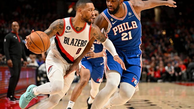 Trail Blazers' Damian Lillard dribbles vs. Sixers' Joel Embiid at the Moda Center in Portland, Oregon.