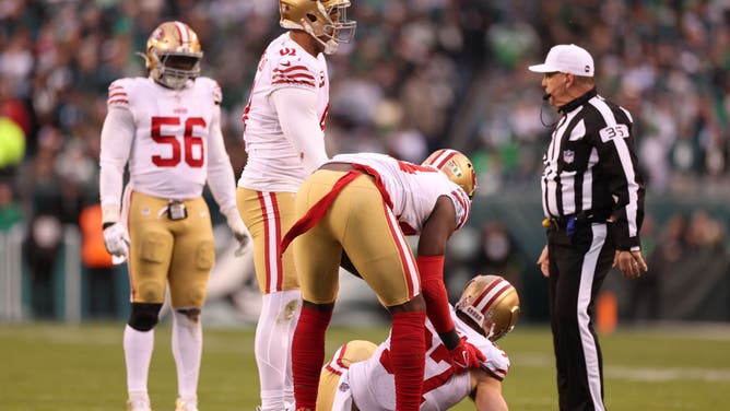 Nick Bosa #97 of the San Francisco 49ers is assisted up after being injured in a play against the Philadelphia Eagles in the NFC Championship Game.