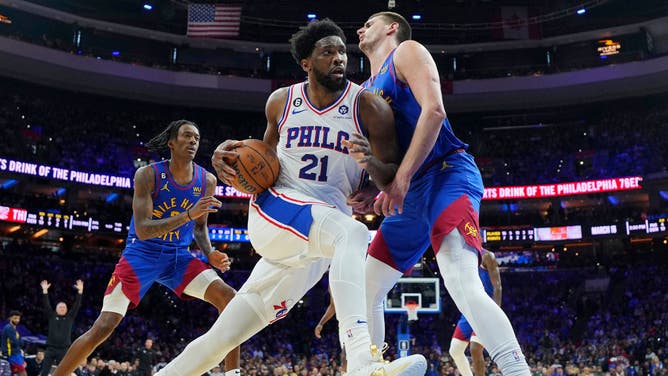 Sixers big Joel Embiid drives to the basket on Denver Nuggets C Nikola Jokic at the Wells Fargo Center in Philadelphia.