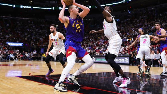 Denver Nuggets C Nikola Jokic drives against Heat C Bam Adebayo at Miami-Dade Arena.