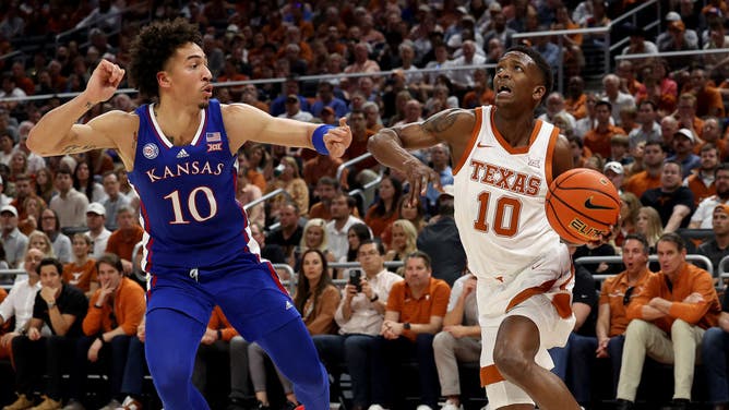Texas Longhorns SF Sir'Jabari Rice drives to the basket on Kansas Jayhawks SF Jalen Wilson at Moody Center in Austin.