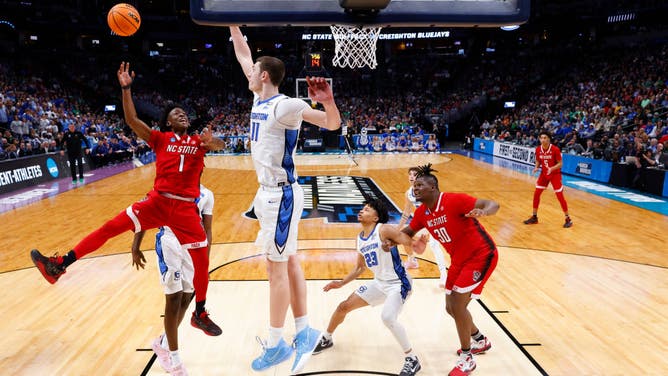 North Carolina State Wolfpack's Jarkel Joiner is met at the rim by Creighton big Ryan Kalkbrenner in the first round of the NCAA Tournament at Ball Arena in Denver, Colorado.