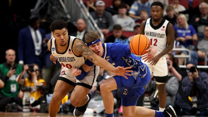 San Diego State PG Matt Bradley battles with Creighton's Baylor Scheierman for the ball during the Elite Eight of the NCAA Tournament at KFC YUM! Center in Louisville, Kentucky.