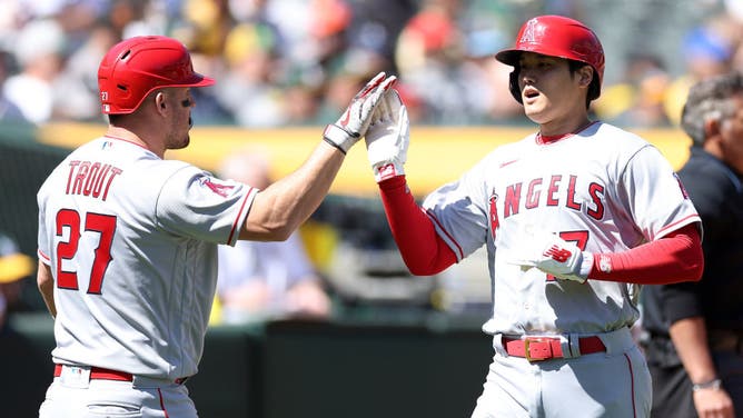 Shohei Ohtani is congratulated by Mike Trout of the Los Angeles Angels after he scored against the Oakland Athletics.
