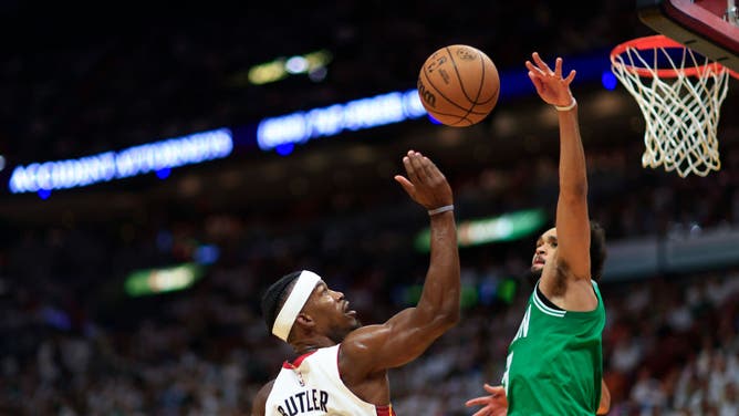 Heat SF Jimmy Butler is met by Boston Celtics SG Derrick White at the rim in Game 6 of the Eastern Conference Finals at Kaseya Center in Miami.
