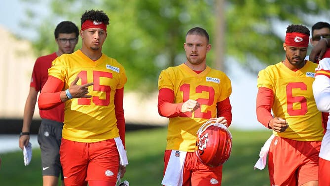 Kansas City Chiefs quarterbacks, from left, Patrick Mahomes, Shane Buechele and Chris Oladokun take the field for a training camp practice.