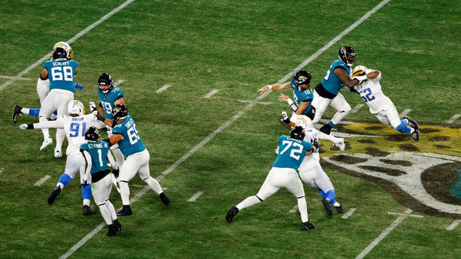 Jaguars QB Trevor Lawrence throws a pass during the AFC wild card round vs. the Los Angeles Chargers at TIAA Bank Field in Jacksonville, Florida.