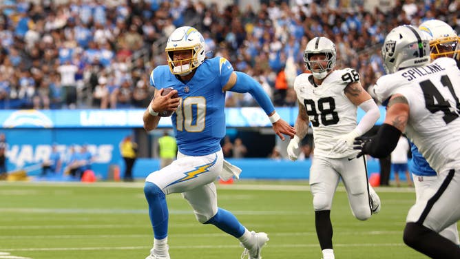 Los Angeles Chargers QB Justin Herbert scrambles away from the Las Vegas Raiders at SoFi Stadium.