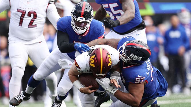 Giants defensive linemen Dexter Lawrence II and Kayvon Thibodeaux sack Washington Commanders QB Sam Howell at MetLife Stadium in East Rutherford, New Jersey.