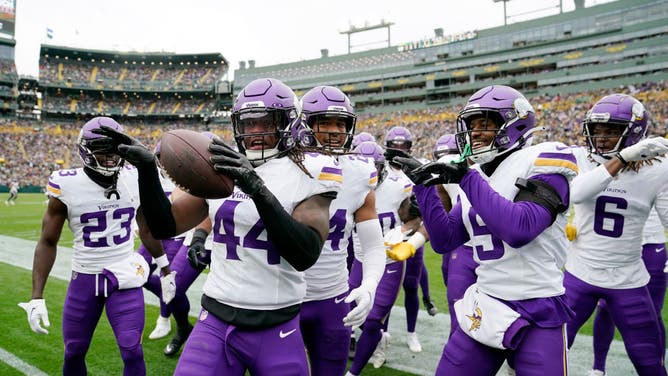 The Minnesota Vikings celebrate after intercepting a pass by Packers QB Jordan Love at Lambeau Field in Green Bay, Wisconsin.