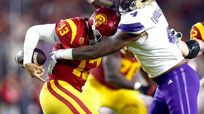 Caleb Williams of the USC Trojans fumbles the ball against the Washington Huskies.