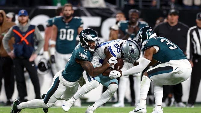 Eagles CB Darius Slay and S Kevin Byard tackle Cowboys WR CeeDee Lamb at Lincoln Financial Field.
