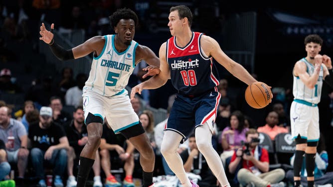 Hornets C Mark Williams guards Washington Wizards SF Danilo Gallinari at Spectrum Center in Charlotte, North Carolina.