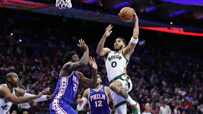 Boston Celtics SF Jayson Tatum goes to the rack on 76ers big Joel Embiid at the Wells Fargo Center in Philadelphia.