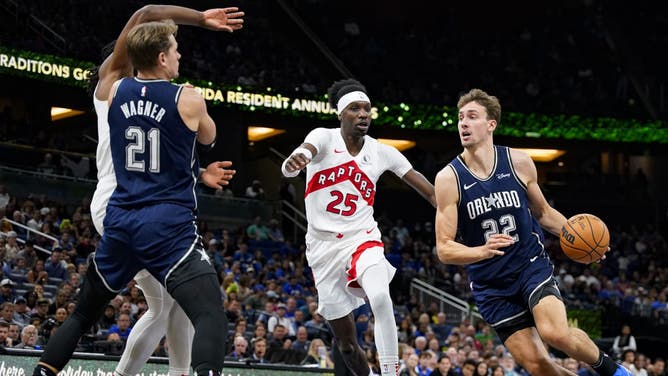 Magic wing Franz Wagner drives past Toronto Raptors big Chris Boucher during an NBA In-Season Tournament game at Amway Center in Orlando, Florida.