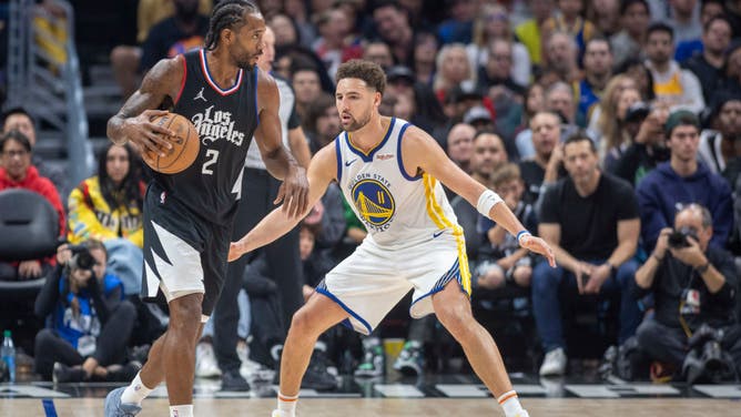 Clippers wing Kawhi Leonard handles the ball against Golden State Warriors SG Klay Thompson at Crypto.com Arena in Los Angeles.