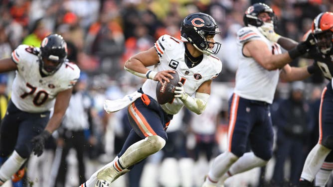 Justin Fields of the Chicago Bears runs with the ball during the fourth quarter of a game against the Cleveland Browns at Cleveland Browns Stadium.