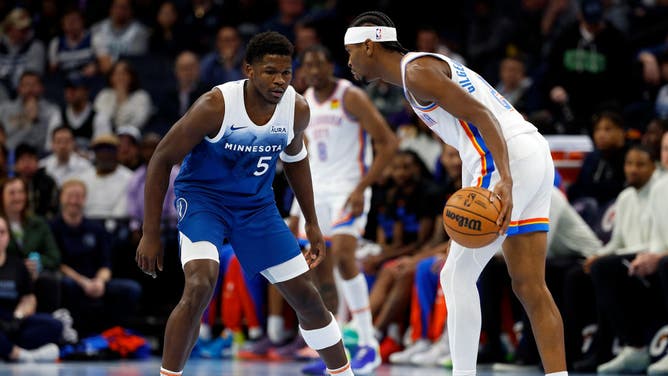 Thunder All-Star Shai Gilgeous-Alexander cradles the ball while Timberwolves wing Anthony Edwards defends him during an NBA In-Season Tournament game at Target Center in Minneapolis.