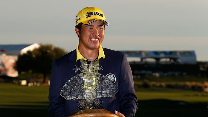 Hideki Matsuyama poses with the winners trophy of the 2016 Waste Management Phoenix Open at TPC Scottsdale in Arizona.