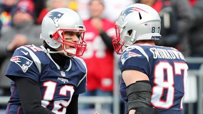 Rob Gronkowski (87) of the New England Patriots reacts with Tom Brady (12) after catching a touchdown pass during the second quarter of a game against the Buffalo Bills at Gillette Stadium Dec. 24, 2017, in Foxboro, Mass.