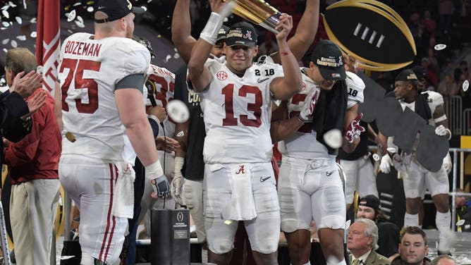 Alabama Crimson Tide QB Tua Tagovailoa lifts the College Football Playoff National Championship Trophy after beating the Georgia Bulldogs at Mercedes-Benz Stadium in Atlanta.